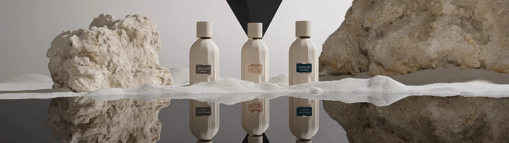 Three elegant beige perfume bottles on sand with rocky background and soft reflections