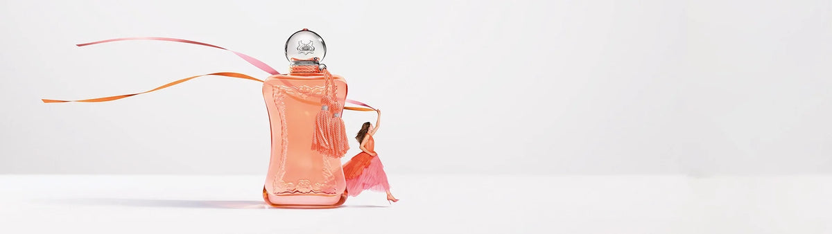 Luxury perfume bottle with embossed horses, man walking, Parisian architecture in background.