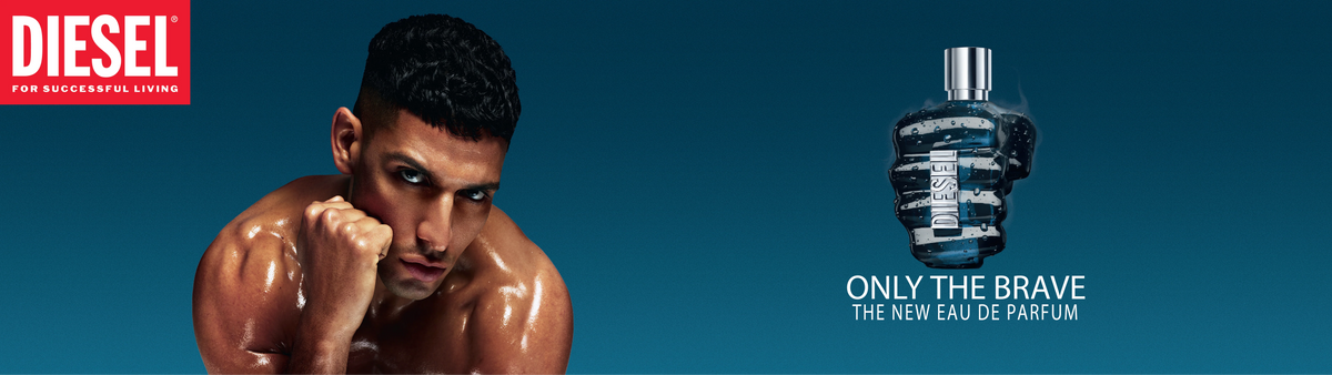Shirtless man surrounded by hands holding Diesel RED perfume bottle, bold red lighting, fragrance ad