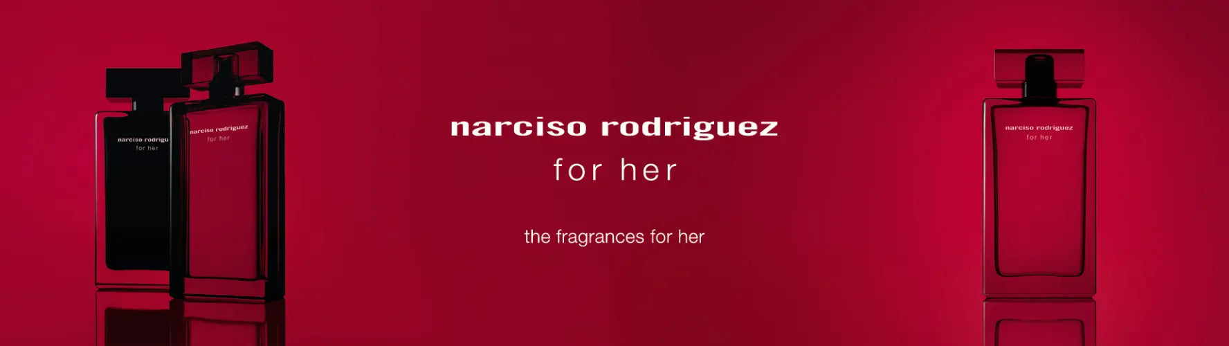 Narciso Rodriguez pink perfume bottle with white flowers and soft fabric background